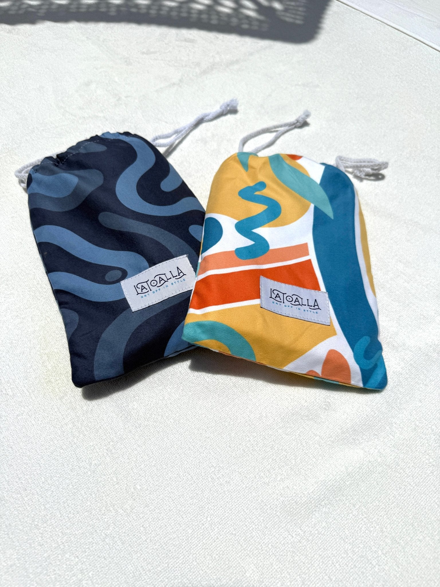 Two drawstring bags with colorful patterns on a light background