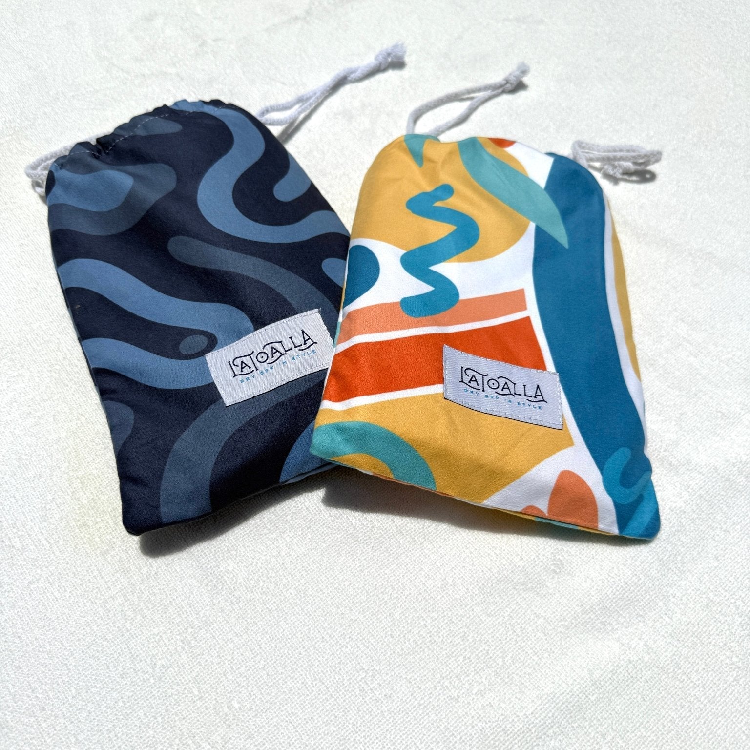 Two drawstring bags with colorful patterns on a light background