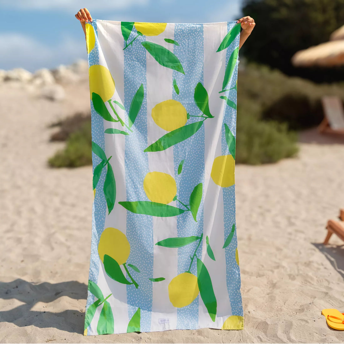 A girl holding a Quick Dry, Sand Free, Light Weight, Compact and Ecofriendly Microfiber Beach Towel from La Toalla